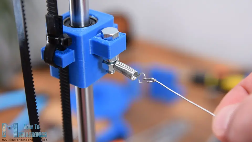 Attaching the hot wire to the Y-axis sliding block with help of extension springs