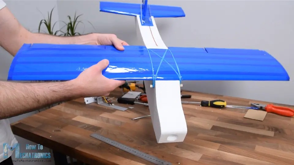 Securing the RC Plane wing to the fuselage with rubber bands