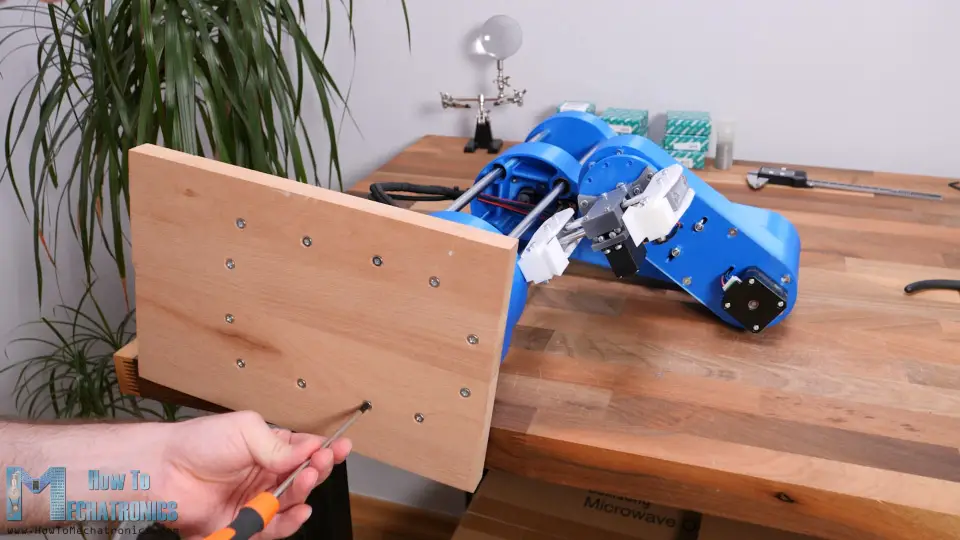 Adding a piece of wood as a base to the robot